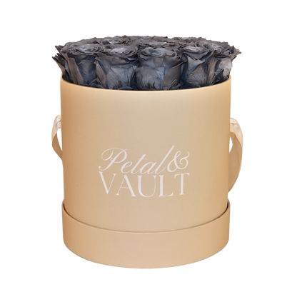 Round Beige hat box with blue roses and 'Petal & Vault' branding on a white background